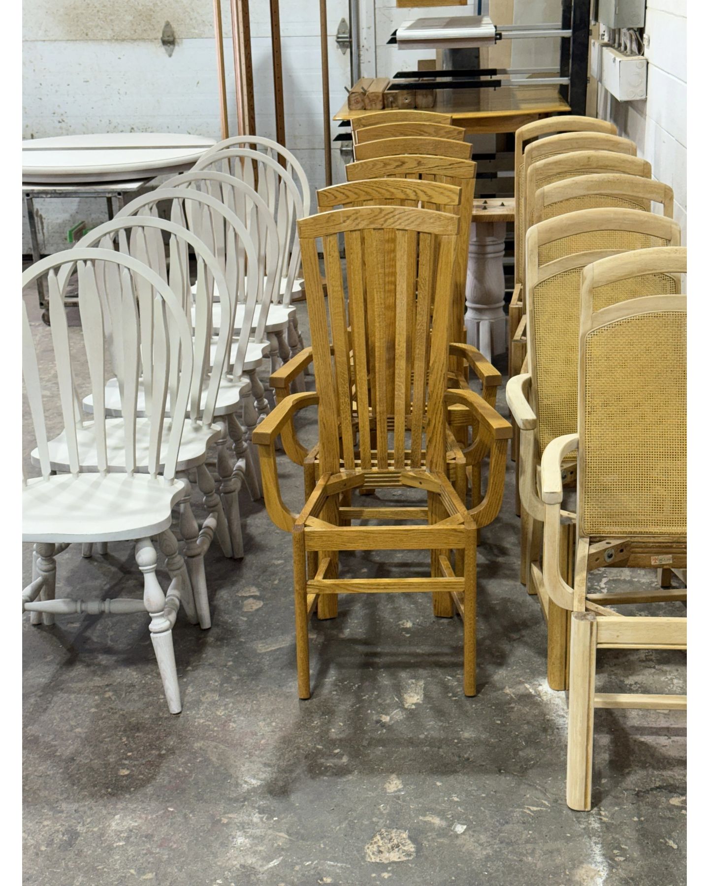 Multiple dining chairs in various styles and finishes